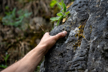 Close-Up Of Pinch Hold During Sport Climbing: Chalked Hand Gripping Rough Limestone Rock Surface With Precision And Strength In Outdoor Climbing Area In Bavaria, Germany