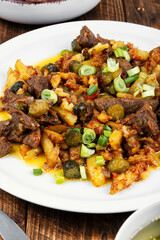 Azu is a traditional dish of Tatar cuisine on wooden surface.