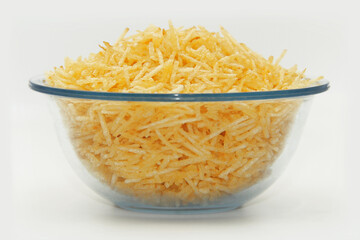PORTION OF STRAW POTATOES IN A GLASS BOWL, FRONT VIEW
