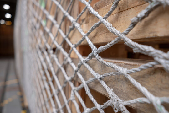 Wooden crates secured with netting inside warehouse