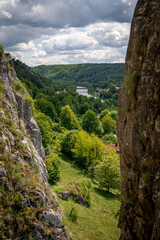 Rock Climbing Crag At Prunner Wall In The Bavarian Jura: Sharp Limestone Pinnacles Rising From Forest Floor Surrounded By Lush Green Trees In A Popular Outdoor Climbing Area In Bavaria, Germany