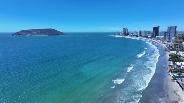 Aerial Mexico Mazatlan city sandy beach. Commercial ocean vacation tourism seaport, cargo and cruise ships. Luxury resort Mexican Riviera. Romantic destination. Sand, surf and beach recreation travel.