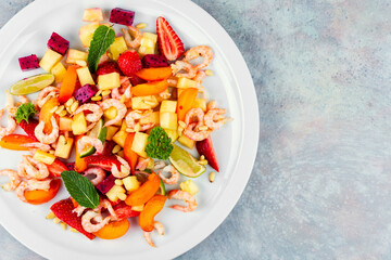 A vibrant shrimp salad featuring tropical fruits.