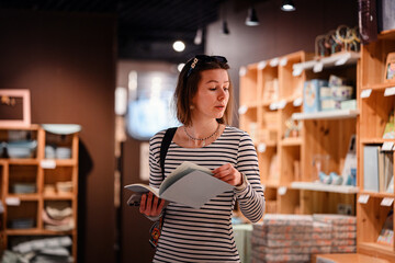 Woman Browsing Stationery in Modern Home Decor Store