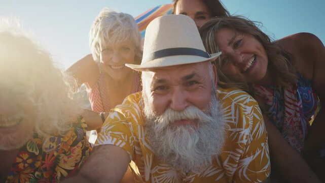 Happy senior people at the beach joyful senior friends are gathering around a charismatic man with long white hair, laughing and embracing on a sunny beach - Powered by Adobe