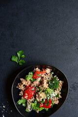 Whole grain pasta salad with tuna and vegetables. Top view with copy space.