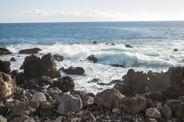 Waves Crashing Against black Lava Rocks on a Tropical Coast, water splashing at canary island Tenerife