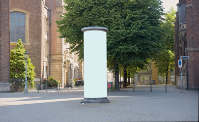 Empty advertising pillar with historic buildings free copy space, free ad space,promotion mock up. Blank advertising panel.