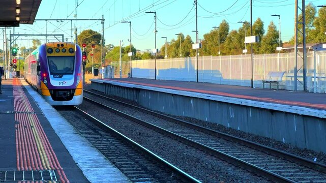 Commuter train approaching a train station in Melbourne Victoria Australia