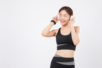 Dance becomes natural when this slim woman wears wireless headphones. A cheerful workout turns into a fun session as she lets herself dance to the rhythm of the music. isolated studio white background