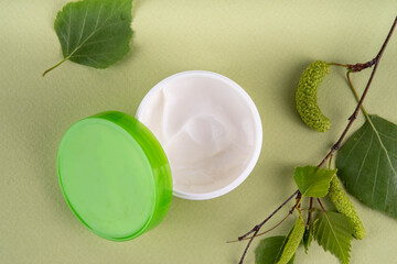 Birch Juice cream, Moisturizer and cleansing gel set of herbal organic facial cosmetics. Natural skin care with birch extracts, in different cosmetics mock-up jars on light green background