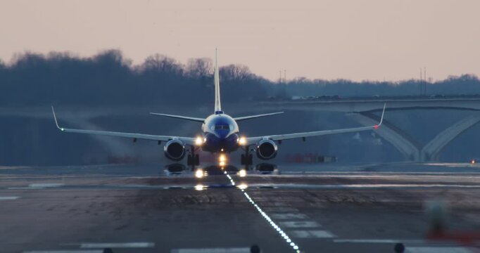 Blue Plane Takes off at Sunset with Camera Tilting to Follow