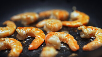 Raw Peeled Shrimp Frying in Hot Skillet Pan.
