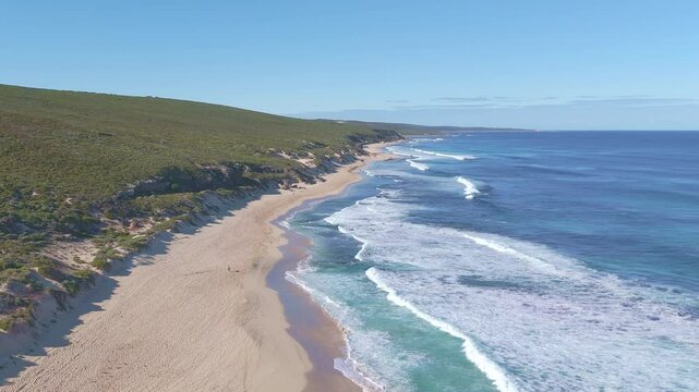 Aerial drone shot of Left Hander Bay, Margaret River, showing powerful ocean waves breaking over a shallow reef