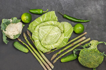Three types of cabbage. Cucumbers, peppers and limes