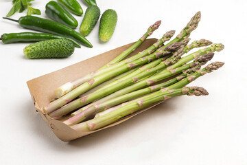 Green asparagus in cardboard disposable dish