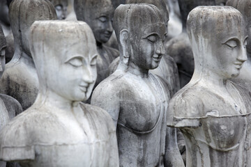 Collection of Stone Statues with Serene Expressions in Rows
