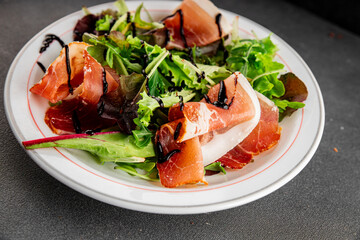 Salad jamon meat green leaf lettuce appetizer food fresh gourmet food background on the table rustic food top view copy space