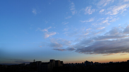 City Dawn with Church Cross and Sunrise Sky in Urban Landscape