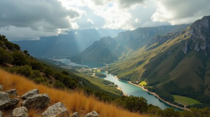 A panoramic view of Sierra del Sueve in Spain at midday, with cloudy skies and lush green valleys.
