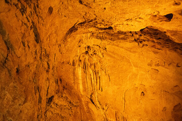 A close-up view of a limestone cave, filled with colorful,curious,wonderful. Lighting enhance texture and geological beauty.