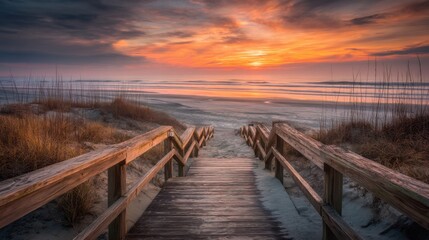 Obraz premium Boardwalk Descent to Sunrise Beach Scene at Serene Coastal Destination with Vibrant Sky and Ocean Waves
