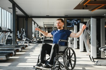 Person with disability, athlete exercising in wheelchair at gym for rehabilitation