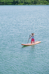 Fototapeta premium woman rowing sup board river water , paddleboard and surfing