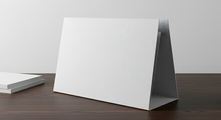 Naklejka premium Blank Card Mockup Standing on Wooden Desk Surface