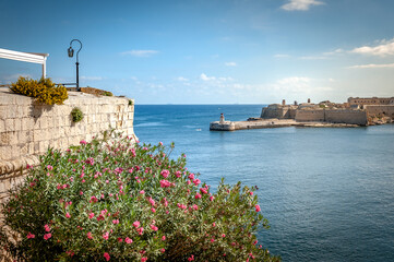Seascape with lighthouses and the walls of the city of Valletta, Malta.