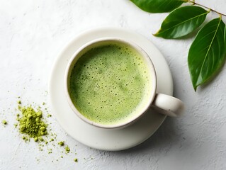 Top view of frothy matcha tea with leaves.