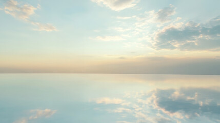 Fototapeta premium Serene landscape featuring tranquil body of water reflecting soft, pastel sky filled with clouds. calmness of scene evokes sense of peace and tranquility