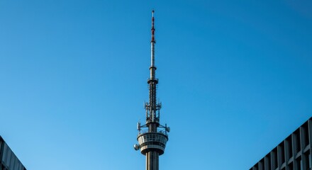 Obraz premium Tall Communication Tower Against Clear Blue Sky Modern Telecommunications Infrastructure