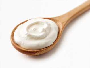 A wooden spoon filled with creamy white yogurt on a clean white background.