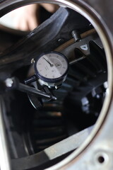 Dial Test Indicator on the stand for accurate measurement backlash crown gear differential komatsu.

