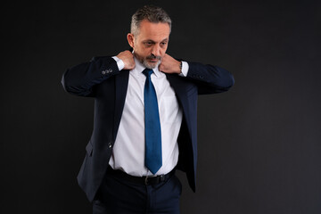 Man adjusting suit jacket collar.