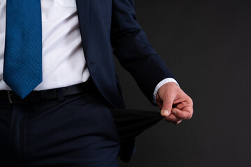 Close-up of businessman showing empty pocket.