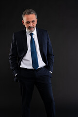 Confident businessman with hands in pockets.