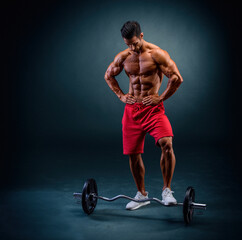 Muscular Man Posing in front of Barbell 