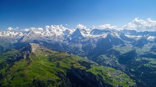 A stunning aerial view of the Swiss Alps, with snow-capped peaks and green valleys