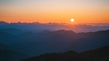 Fototapeta premium A sunset view from a mountain summit, with layers of peaks fading into the distance