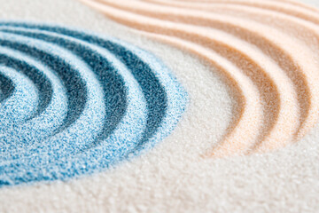 Beautiful white sand with blue and pastel colors, a spiral pattern, a macro shot, a background for design.