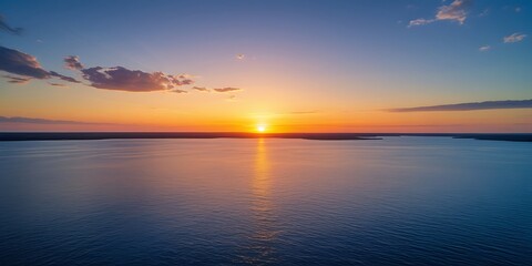 Tranquil Ocean Horizon with Golden Sunrise and Soft Morning Sky