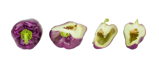 Whole and sliced ​​purple bell peppers on a white background, top view.