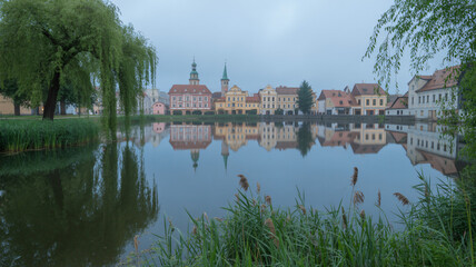 Reflection of Telč s historic center in the morning pond peaceful Czech town