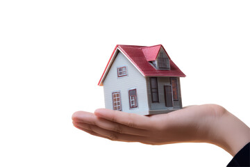 A house miniature with a red roof being held in the palm of a hand against a black background image view on transparent background