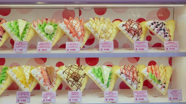 Crepes with whipped cream, different fruit and toppings on display on the Takeshita shopping street in Tokyo, Japan