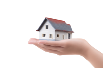 A miniature house with a gray roof and white walls held in a person's hand against a black background on transparent background