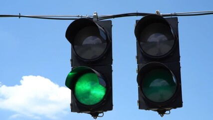 Green Traffic Lights Under Clear Blue Sky Promoting Safe Transportation and Smooth Traffic Flow