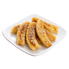 A white plate filled with fried bananas topped with sesame seeds on a black isolated background view on transparent background